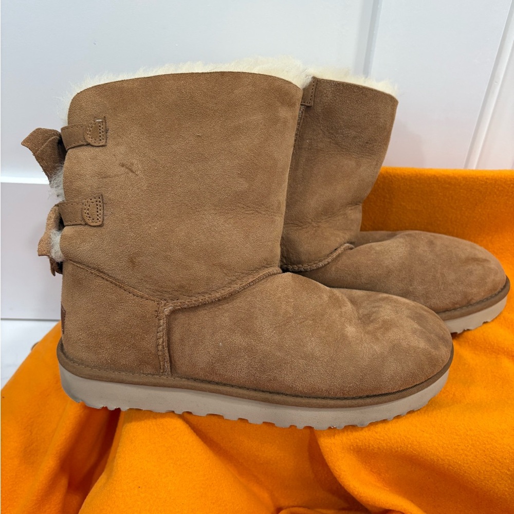 UGG Tan Suede Boots with Shearling Lining and bows on the back.